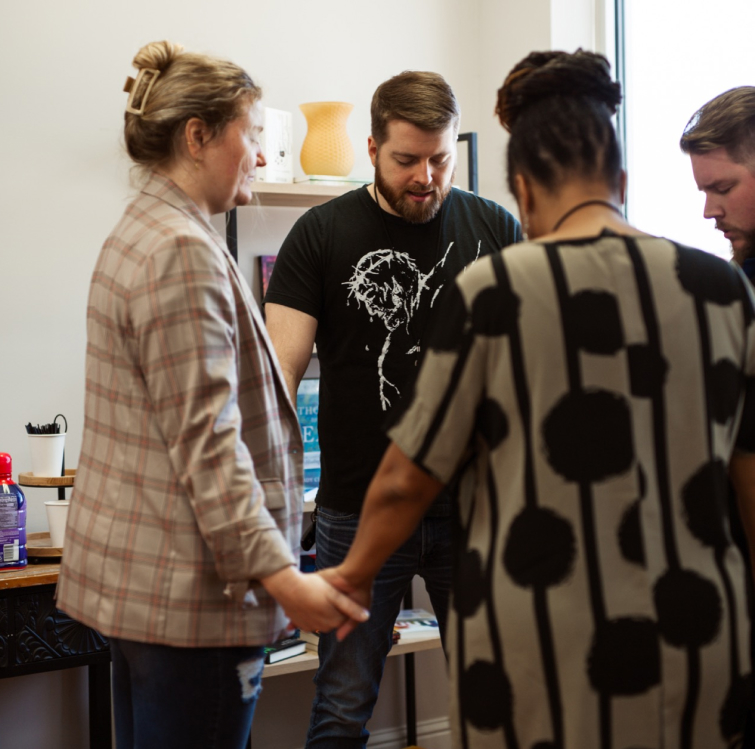 a group praying for ahava church members